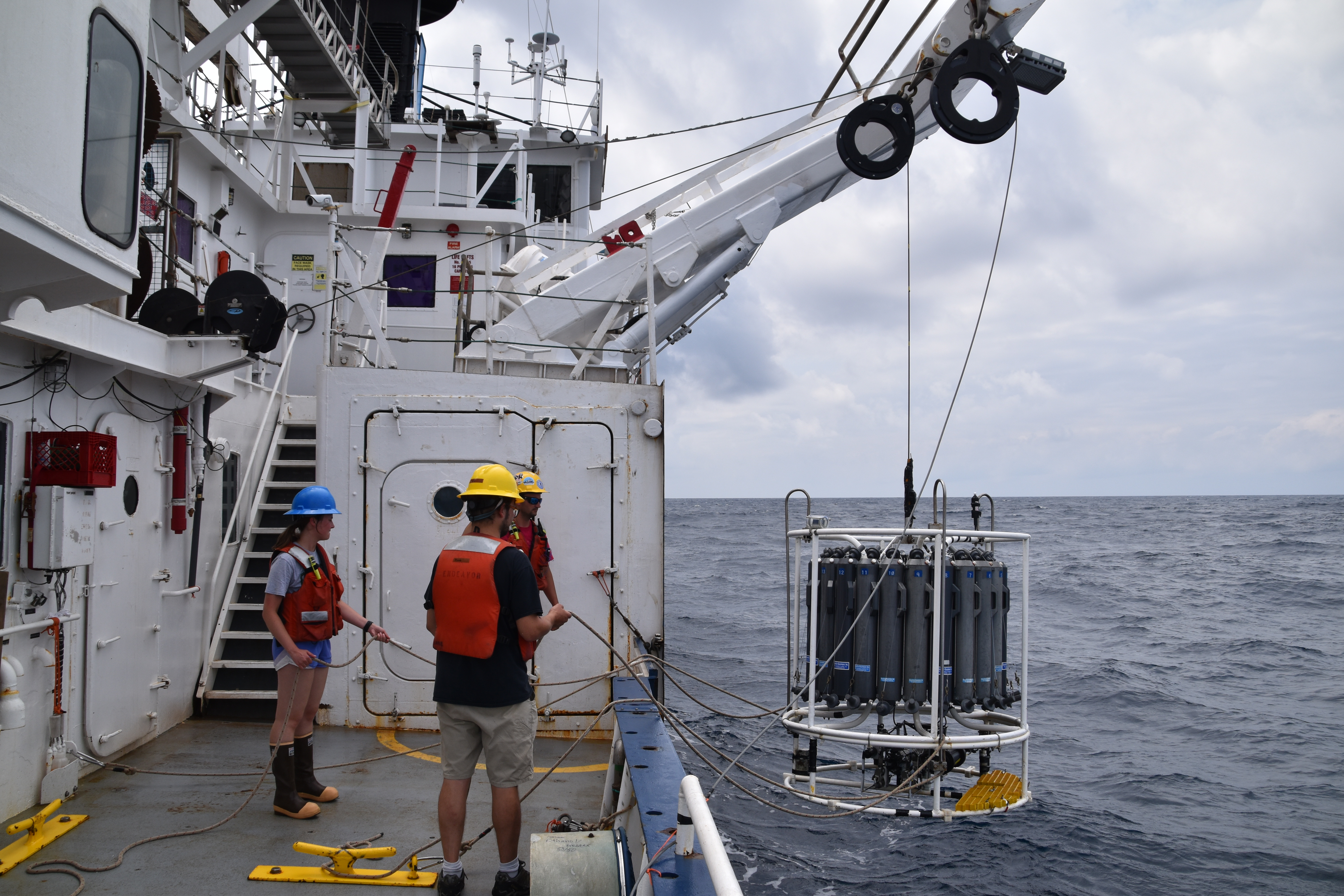 Collecting ocean water from a CTD rosette off the side of the R/V Endeavor research cruise ship in the Atlantic Ocean Northeast shelf.